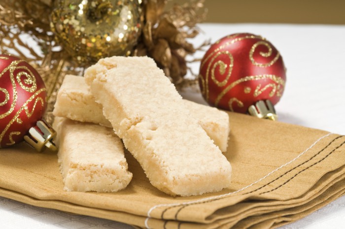 Shortbread cookies sitting on cloth napkin, next to holiday ornament