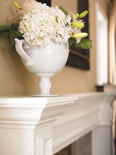 Vase of flowers on fireplace mantel