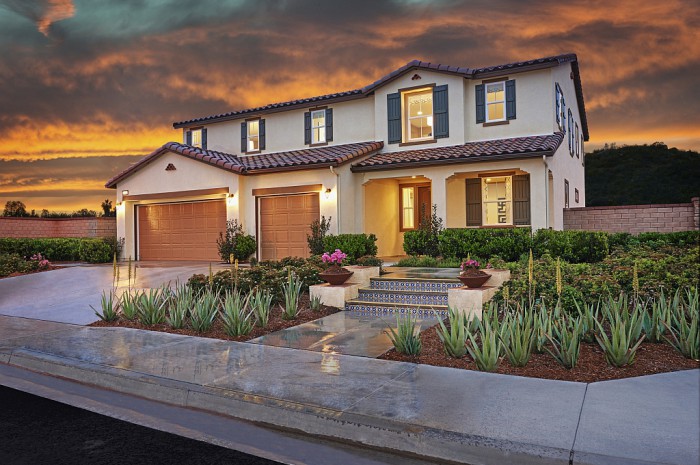 Exterior of two-story home with 3-car garage at sunset