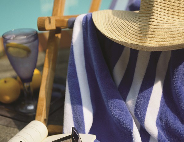 Hat and towel draped over pool chair