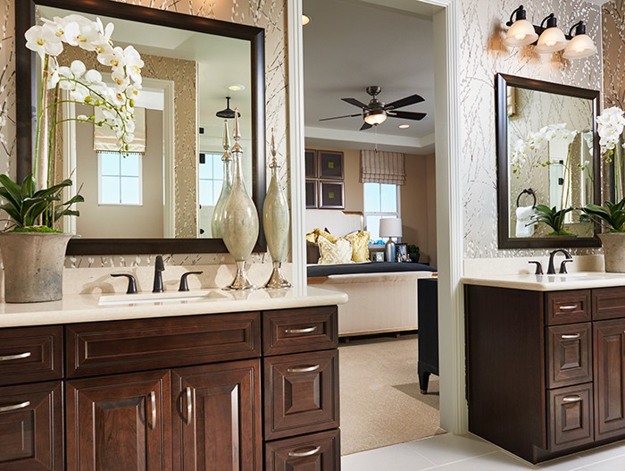 Primary bathroom with dark cabinets and light countertops