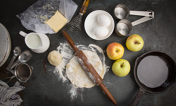 Cooking utensils and ingredients on a dark countertop