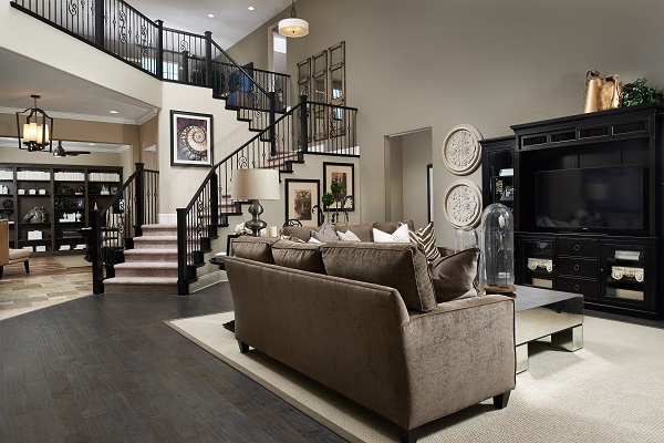 Great room with iron staircase and dark hardwood flooring