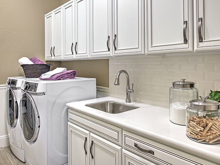 Laundry room with built-in cabinets and sink