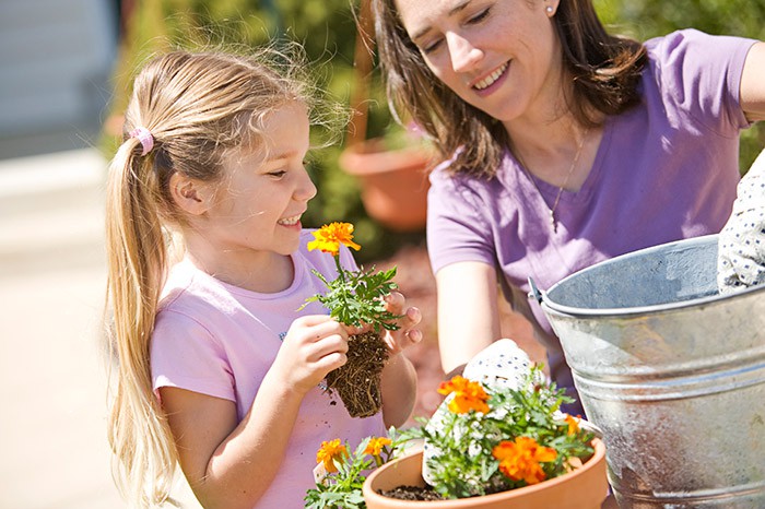 Mother and daughter planting flowers