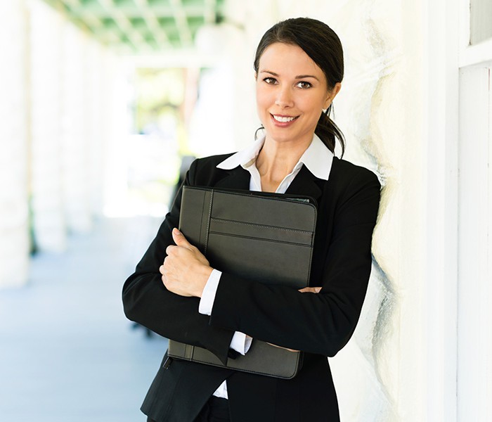 Real estate agent holding binder