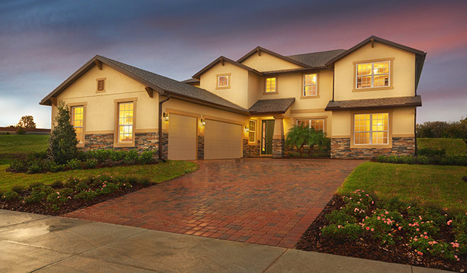 Exterior of two-story home with concrete-paver driveway