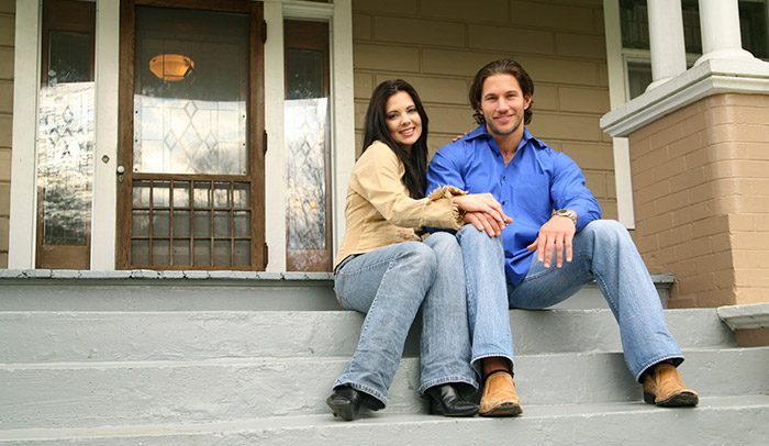 Couple sitting on front porch steps