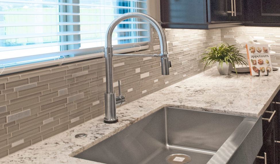 Kitchen sink with stainless-steel faucet and mosaic tile backsplash