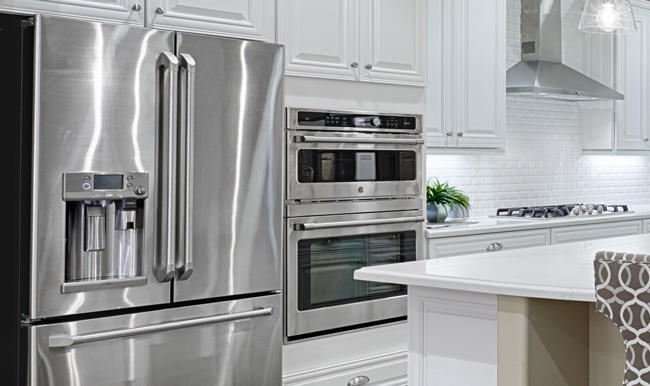 Kitchen with white cabinets, subway tile backsplash and stainless-steel French door refrigerator