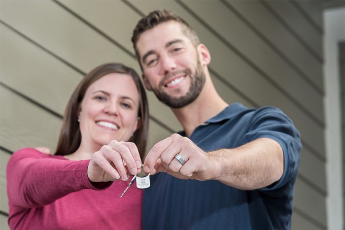 Couple holding keys to new home