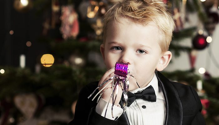 Little boy in tuxedo celebrating New Year's