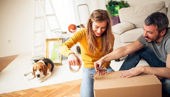 Happy couple packing boxes