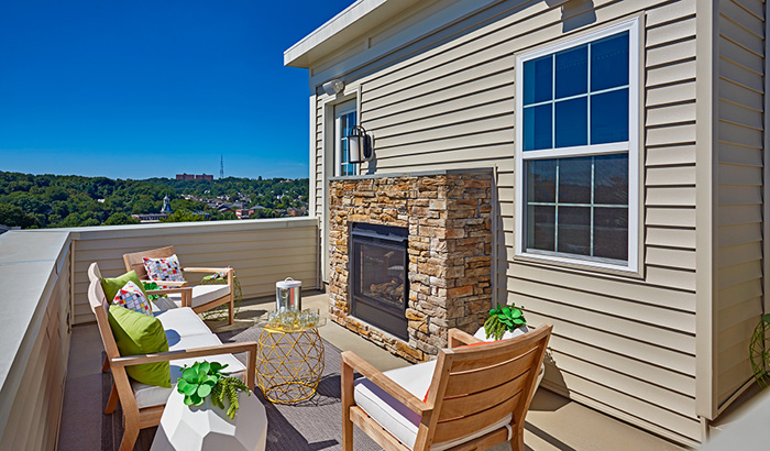 Rooftop terrace with outdoor fireplace and sitting area