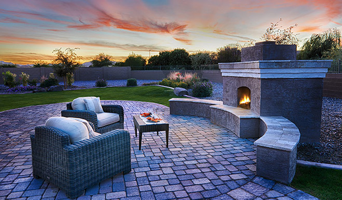 Outdoor fireplace and sitting area in backyard