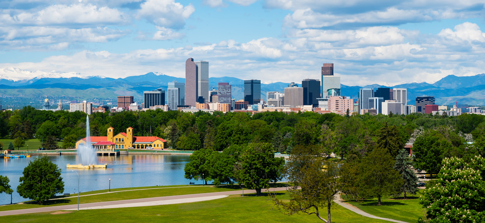 Park lake with Denver skyline and mountains behind
