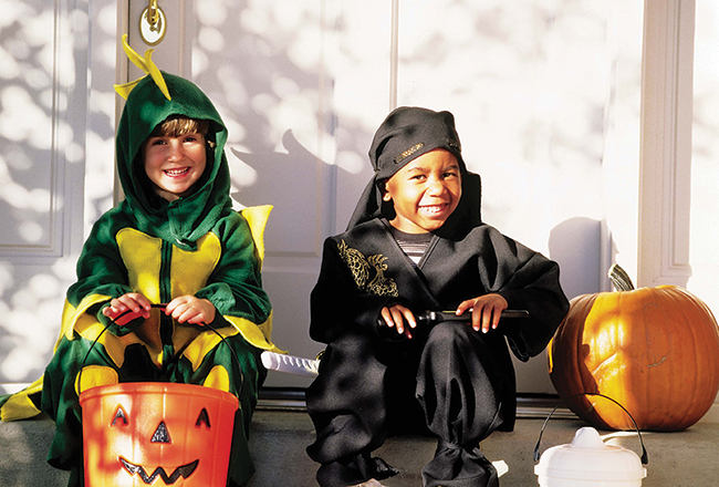 Two children dressed in Halloween costumes