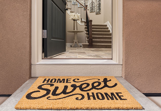Home Sweet Home welcome mat in front of front door