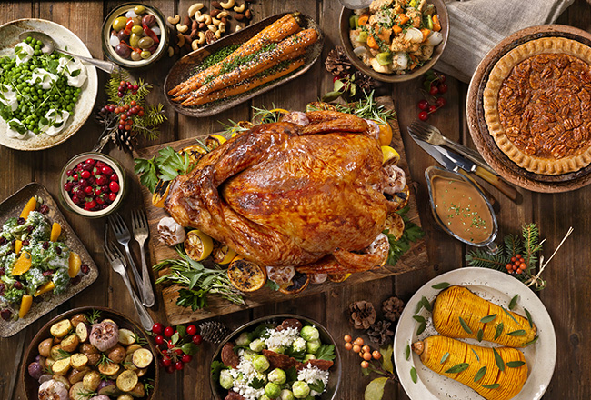Thanksgiving dinner of turkey surrounded by side dishes