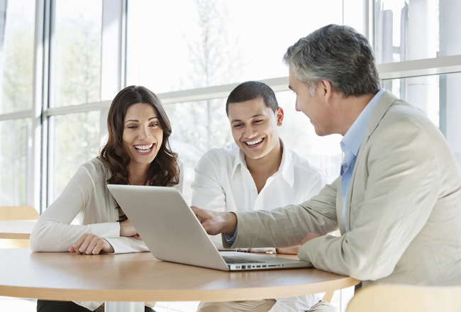 Couple discussing FHA loan down payment with loan officer