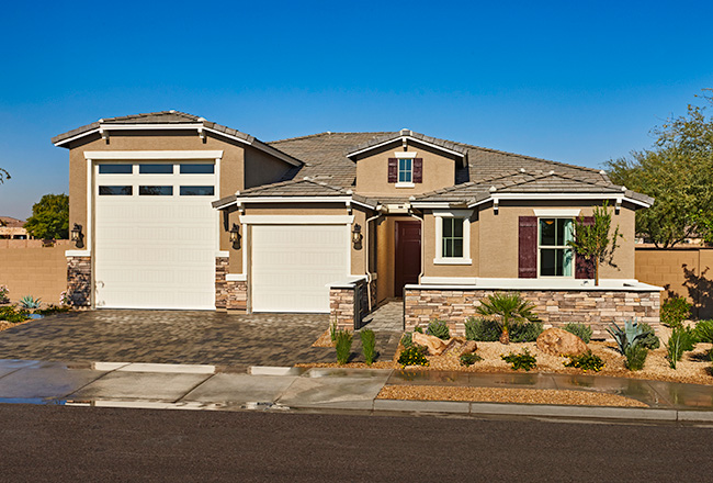 Exterior of home with attached RV garage and concrete-paver driveway