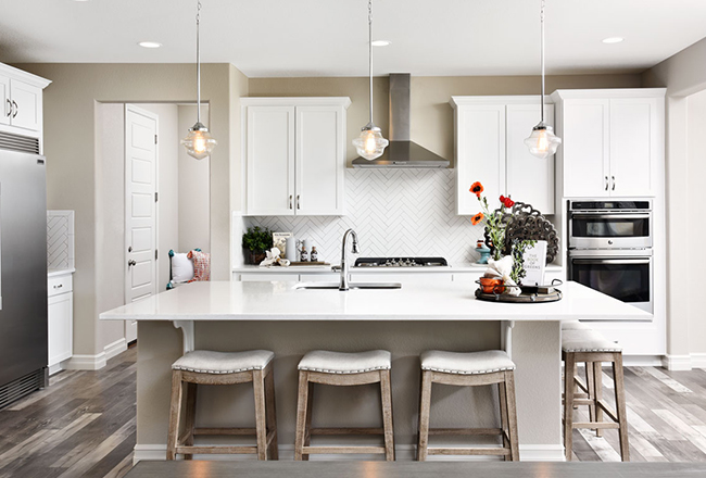 School House pendant lighting in white kitchen with large island