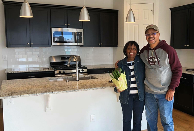 Couple standing in kitchen