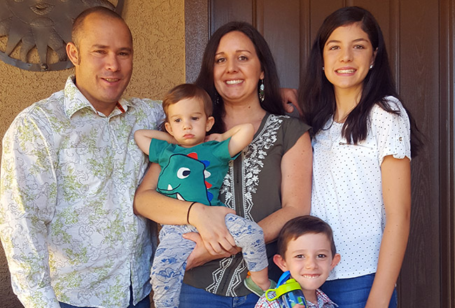 Family of five in front of their front door