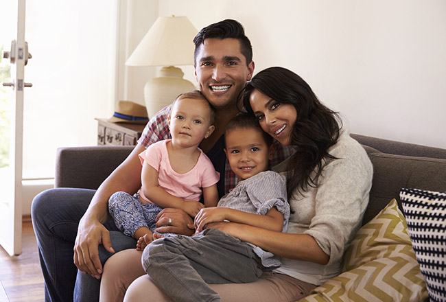 Family sitting on sofa