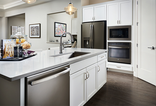 Kitchen with white cabinets and slate appliances