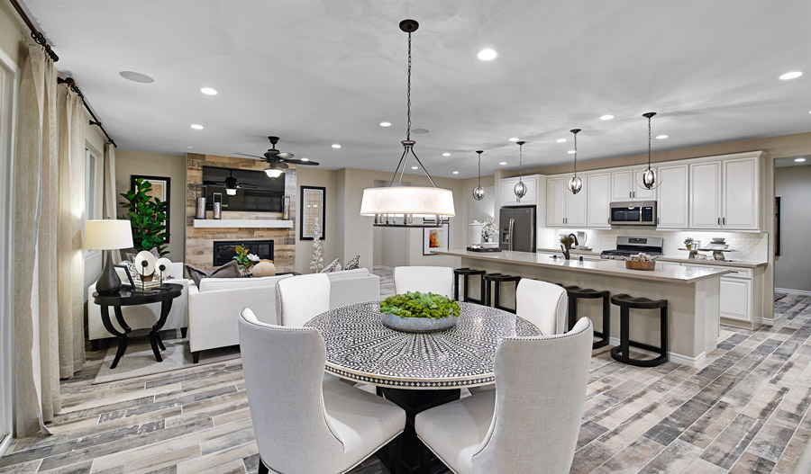 Dining nook and kitchen with center island, chandelier and elegant pendant lights