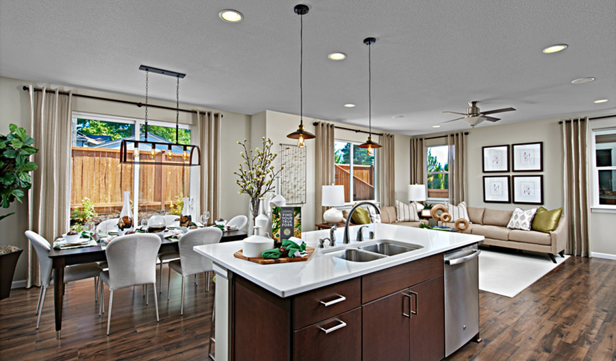 Dining nook and kitchen island with vintage-looking pedant lights