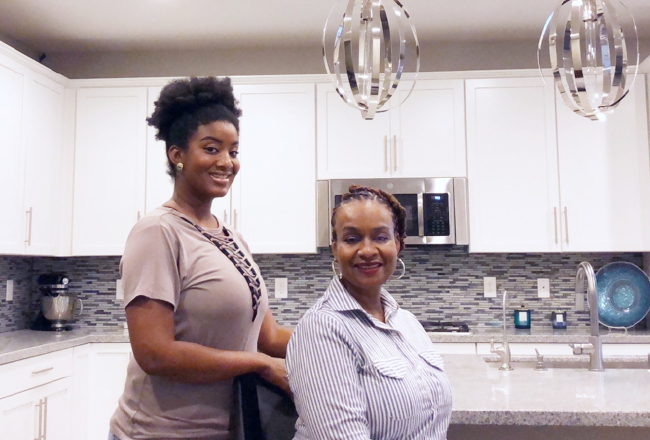 Mother and daughter in kitchen with white cabinets