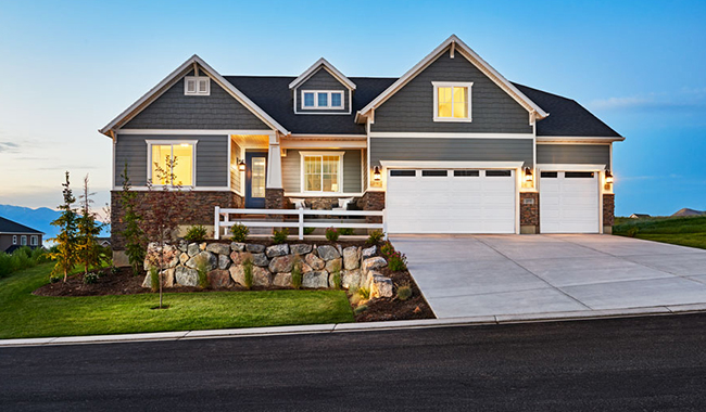 Exterior of ranch-style home with covered porch and 3-car garage