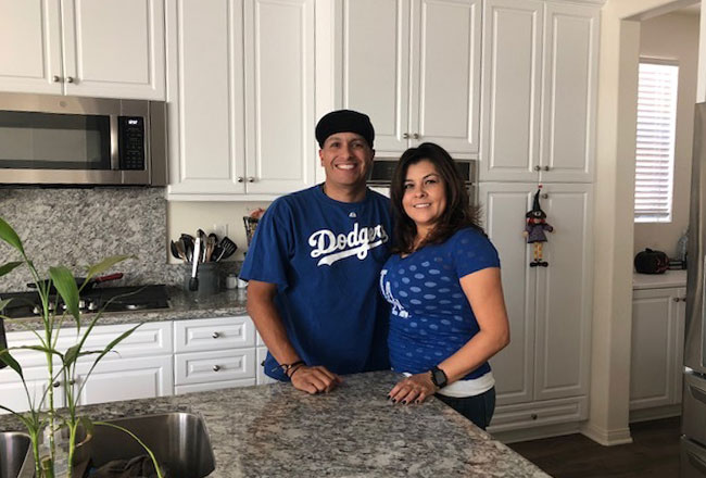 Happy couple in kitchen of their home