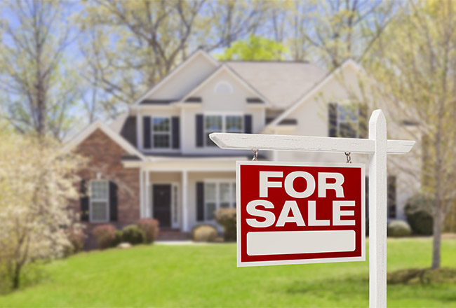 Home with For Sale sign in front yard