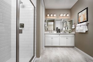 White subway shower tile in owner's bath