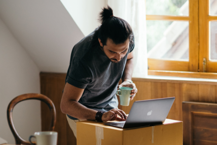 Man at laptop, posting garage sale ad