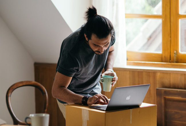 Man at laptop, posting garage sale ad