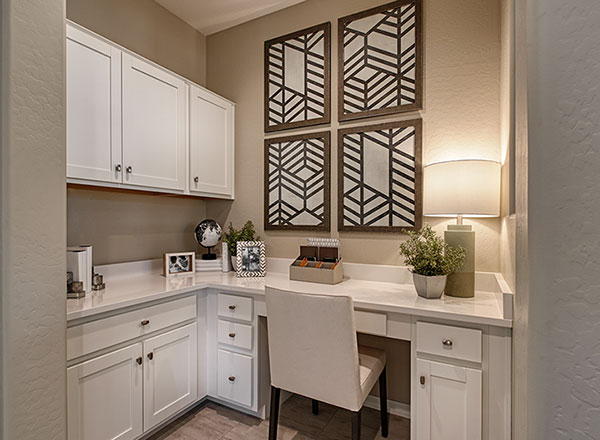 Homework station with white cabinets and desk