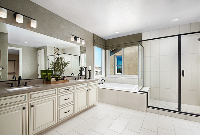 Owner's bathroom with walk-in shower and light cabinets and flooring