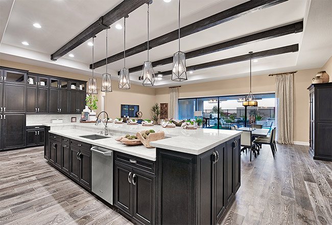 Kitchen island with dark cabinets and light natural stone countertops