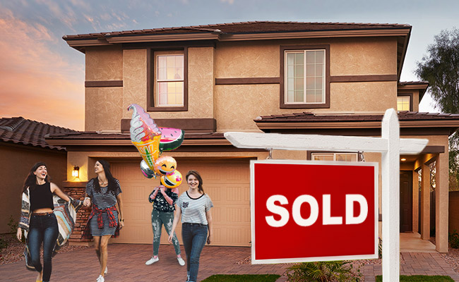 Exterior of home with Sold sign and four people in driveway, including one holding a balloon bouquet