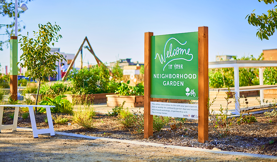 Garden with sign saying 'Welcome to your Neighborhood Garden'