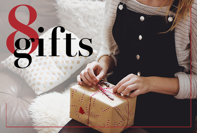 Person about to unwrap gift that is sitting on her lap