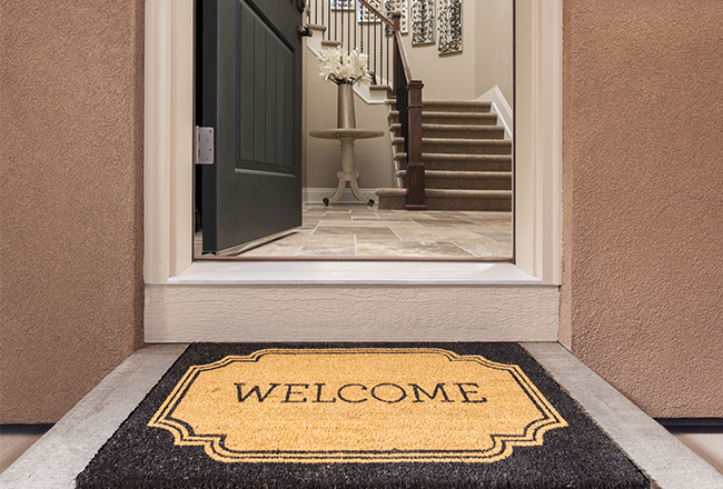 Welcome mat in front of open front door