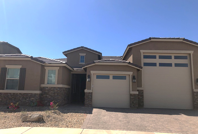 Exterior of a Deacon home with an RV garage and a concrete paver driveway