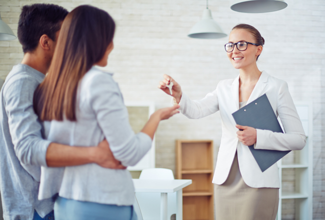 Couple talking to real estate agent