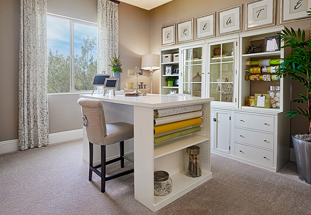 Home craft room with desk and shelves