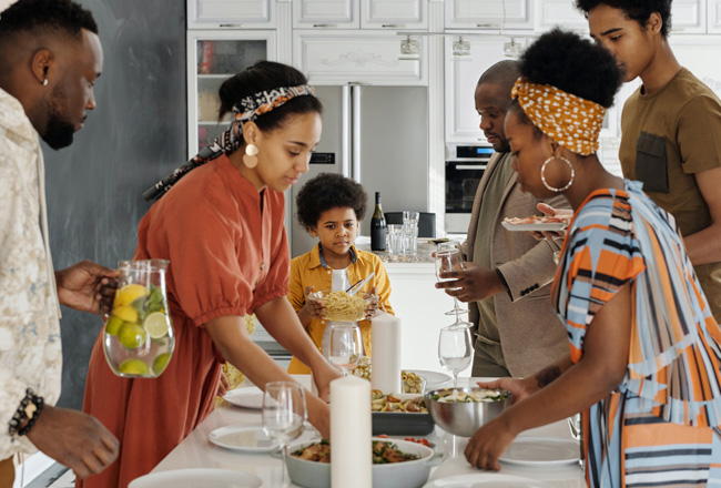 Family gathered around table with food